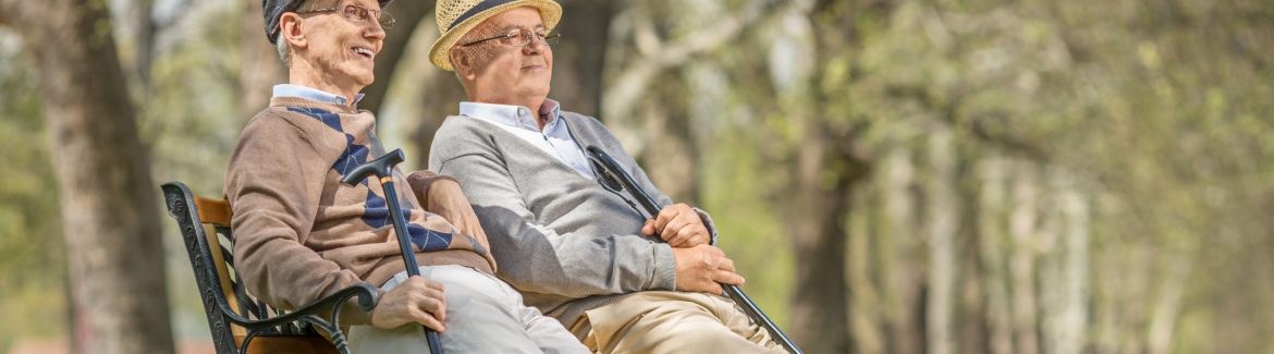 Two seniors sitting and relaxing in a park
