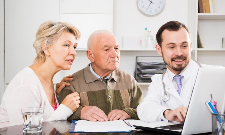 Old father with daughter visit doctor