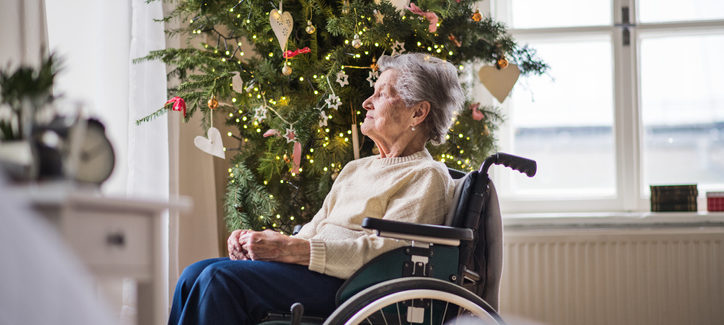 A senior woman in wheelchair at home at Christmas time.