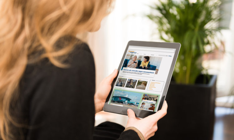 Young woman reading the news on a modern tablet computer